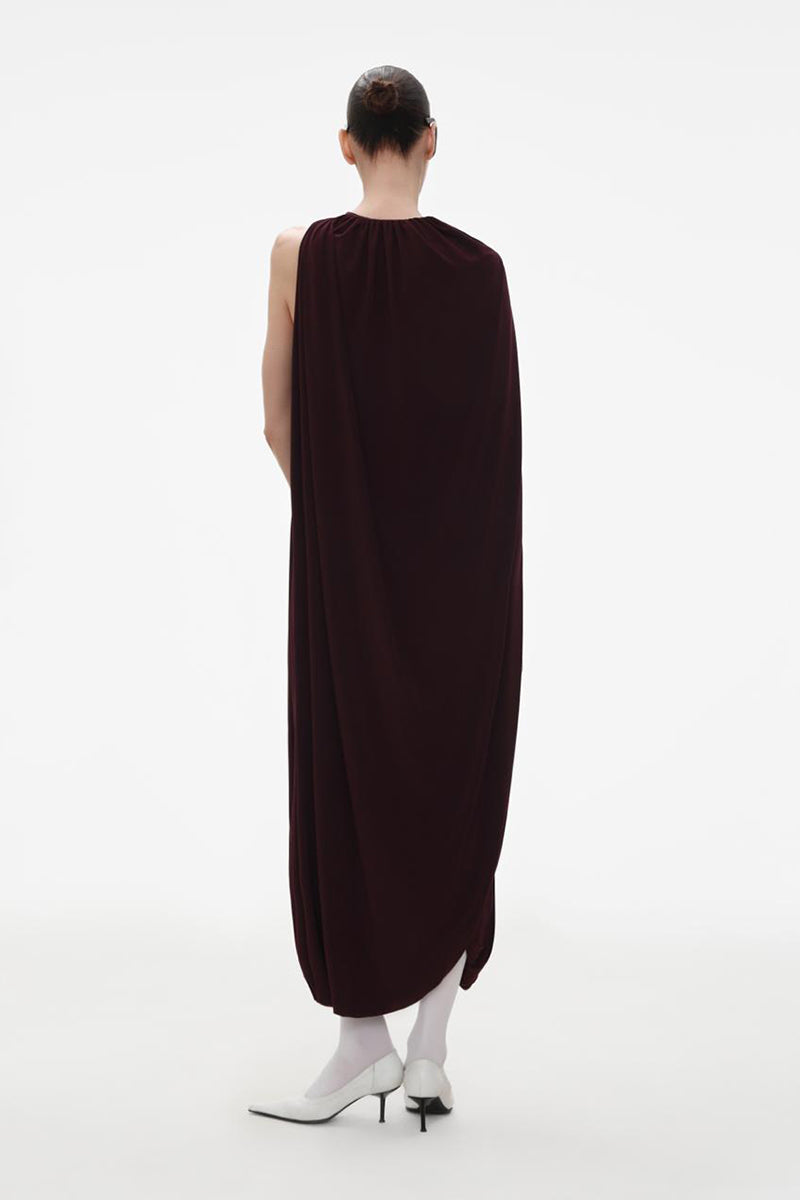 Elegant burgundy jersey midi dress with attached cape by ELENAREVA, displayed on a mannequin with a flowing design.
