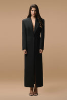 Matters black Celine coat displayed on a hanger, showcasing sleek design and tailored fit in a stylish outerwear piece.