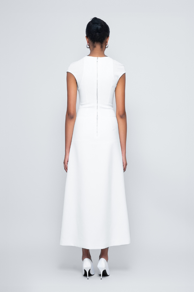 White Squeeze Maxi Dress by TONYY featuring a flowing silhouette and elegant design, perfect for stylish summer or formal occasions.