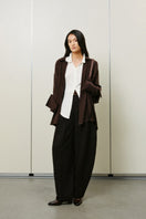 Oversized double-layer cuff shirt by Lecia featuring a relaxed fit and layered sleeve design, shown in a neutral fabric.
