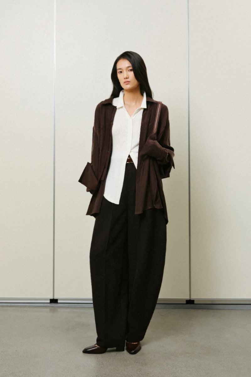 Oversized double-layer cuff shirt by Lecia featuring a relaxed fit and layered sleeve design, shown in a neutral fabric.