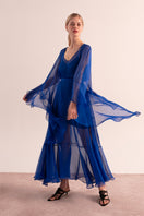 OvertheSea blue maxi dress displayed on a hanger, featuring a flowing design and vibrant color suitable for casual or formal wear.