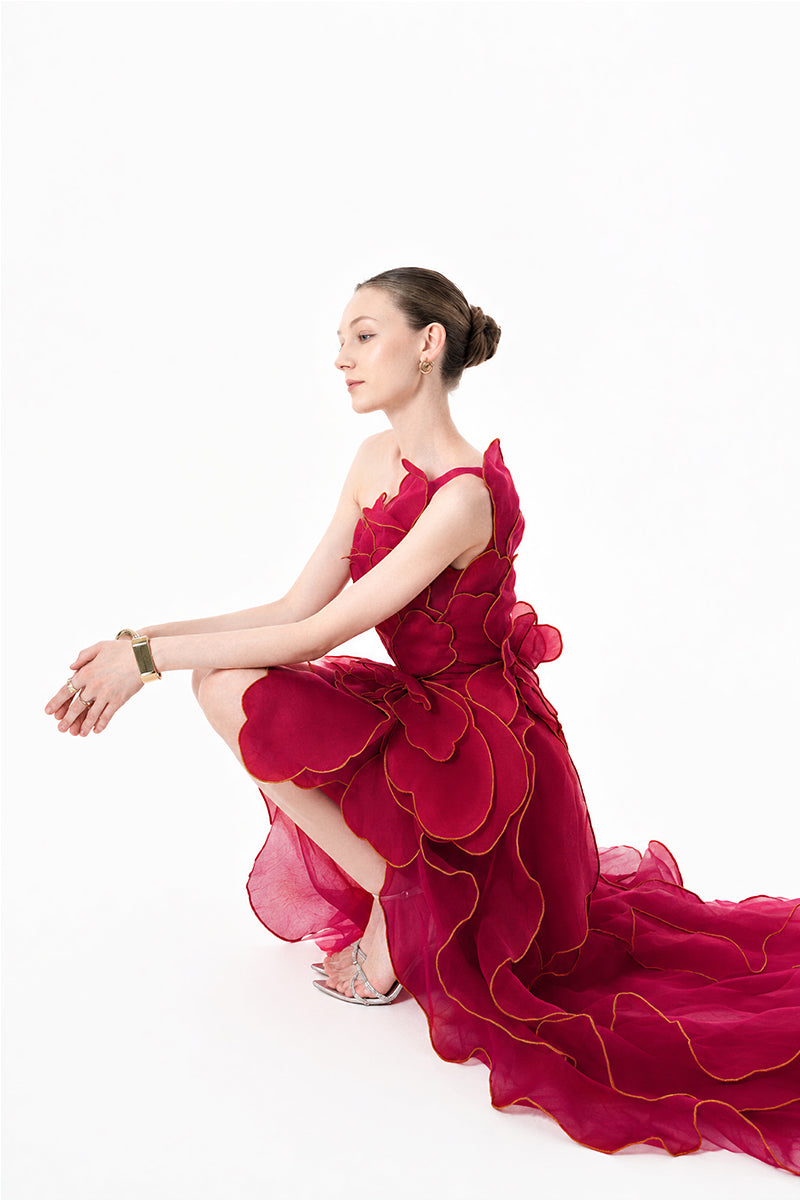 HAPPY CLOTHING CULT MIA X burgundy sculpted petal one-shoulder gown with elegant draping and a fitted silhouette.