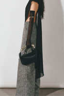 Black asymmetric see-through cape jacket by Lecia, featuring lightweight, sheer fabric and stylish draped design.