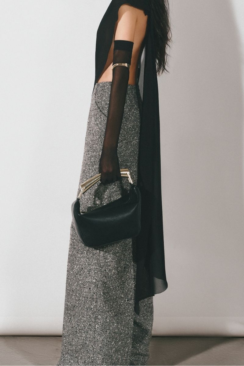 Black asymmetric see-through cape jacket by Lecia, featuring lightweight, sheer fabric and stylish draped design.