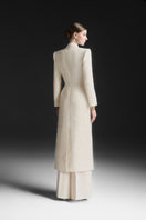 Maison Des Copains ivory cream V-neck trench coat with classic design and tailored fit, displayed on a hanger.