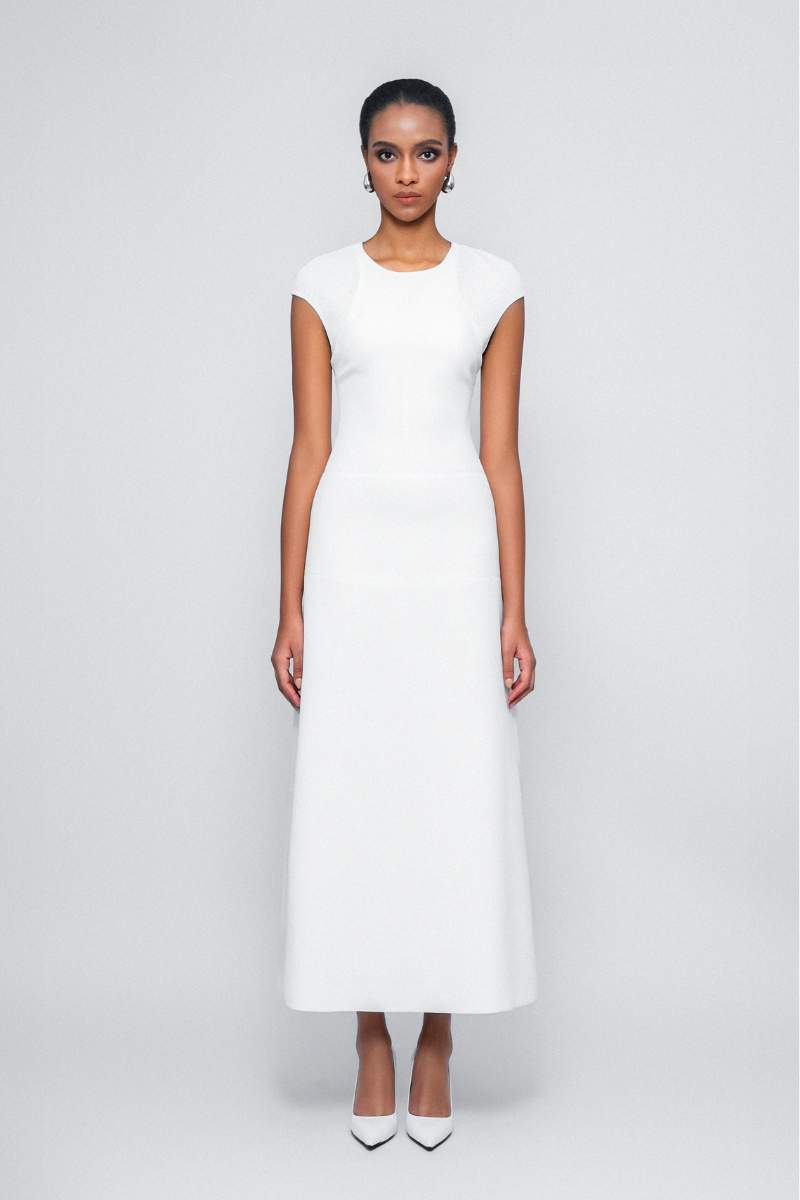 White Squeeze Maxi Dress by TONYY, flowing sleeveless maxi dress with a fitted waist and elegant length.