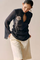 Black Leicia slit front mesh shirt, showcasing its sheer fabric, stylish front slit, and modern tops design.