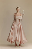 White Plan Veronica gown displayed on a hanger, showcasing its elegant design and flowing fabric.
