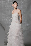 White tulle A-line gown with layered pleats and embellishments, designed by Phan Huy, featuring a flowing, elegant silhouette.