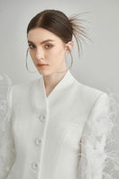 White Jane blazer by Arti Apparel, tailored blazer with a sleek fit, shown on a model with lapel collar and button closure.