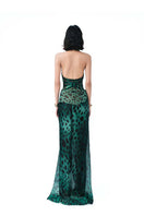 Elegant emerald green Panther Maxi Dress by Do Long, flowing fabric with a flattering silhouette and intricate design details.