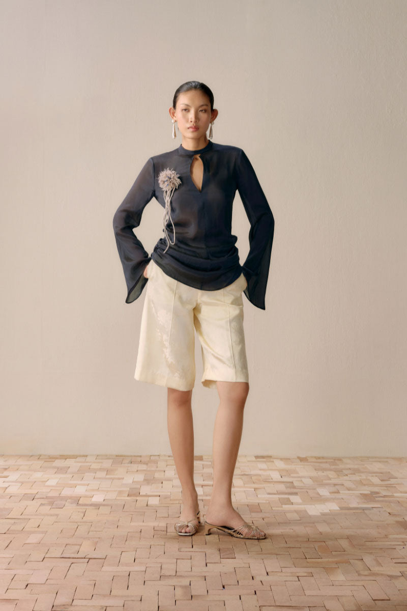 Black Levia slit front mesh shirt, a stylish women’s top with a sheer mesh design and front slit detail.