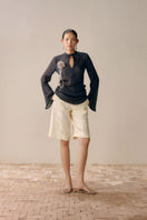 Black Levia slit front mesh shirt, a stylish women’s top with a sheer mesh design and front slit detail.
