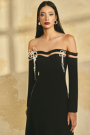L'SCARLETT off-shoulder long-sleeve poly crepe gown with elegant draping and fitted silhouette, shown in a sleek, stylish design.