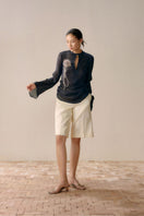 Black Lecca slit front mesh shirt featuring a fashionable design with a front slit and breathable mesh fabric.
