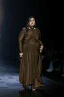 Chocolate brown fitted maxi dress by Deme By Gabriella, featuring a sleek silhouette and elegant length in a close-up view.