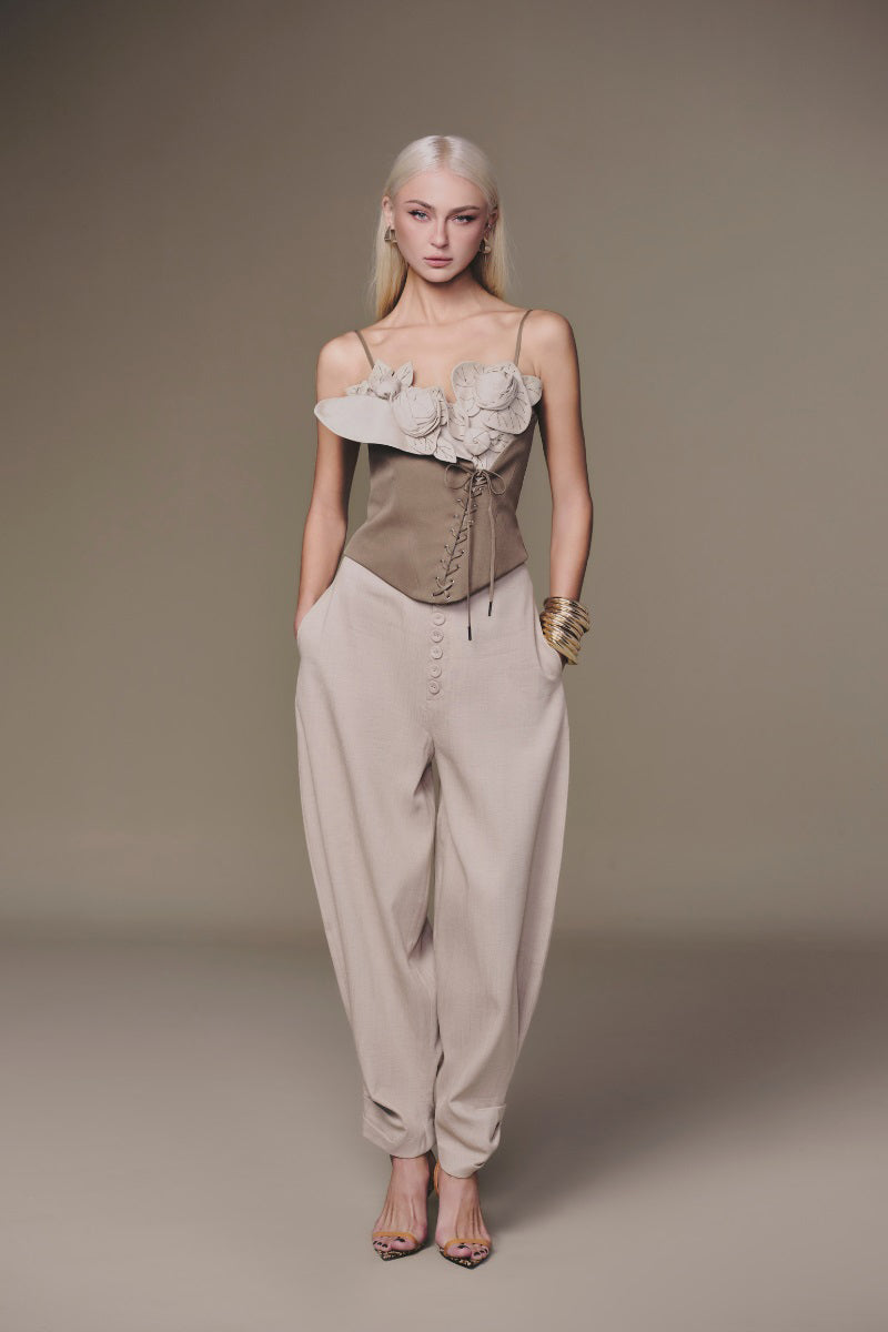 Beige button baggy pants by Keira Tong, featuring relaxed fit and casual style, shown with pockets and wide leg design.