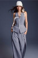 Keira Tong bouquet sleeveless vest displayed on a hanger, featuring a floral print and fitted silhouette.