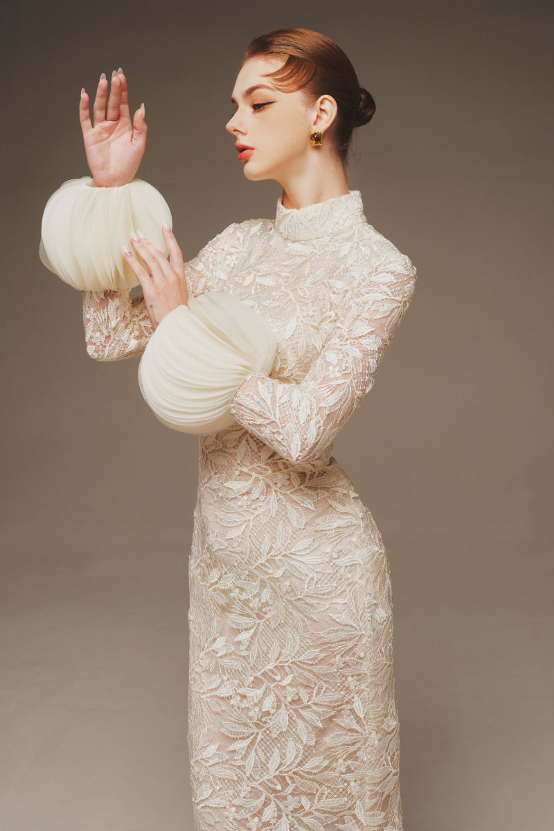 Margée Atelier Aura Lace Column Dress, a navy maxi dress with intricate lace details and a fitted silhouette.