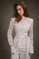 Keira Tong lace wrap top featuring delicate lace fabric and a stylish wrap design, perfect for elegant casual wear.