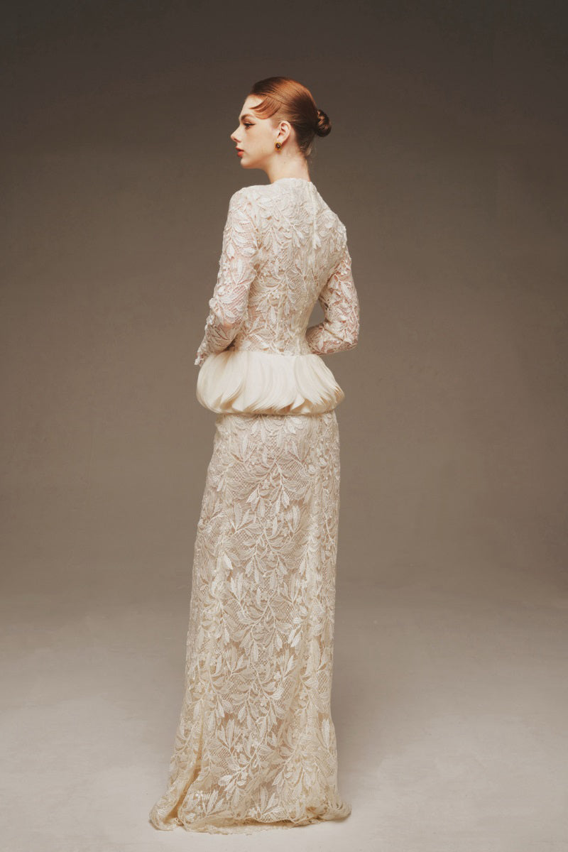 Elegant Margée Atelier Ethereal Lace Peplum Gown, a flowy maxi dress with intricate lace details and a fitted peplum waist.