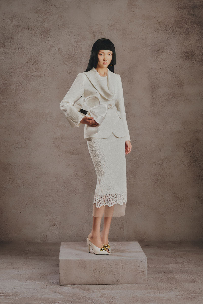 White Plan ivory lace co-ord set featuring a tailored blazer and matching trousers, styled for a chic, elegant look.