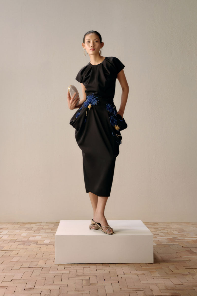Full-brown A-line midi skirt by Levia showcasing a sleek, flowing design with a comfortable fit and elegant silhouette.