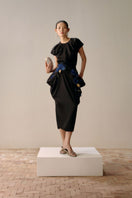 Black full-blown A-line midi skirt by Lecia, flowing fabric with a fitted waist and flared hem, displayed on a hanger.