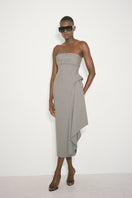 Nué Dylan midi dress displayed on a model, featuring a stylish, flowing design perfect for casual or semi-formal occasions.