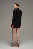 Black oversized double-breasted blazer from I.H.F Studio, shown on a mannequin with lapels and button details.