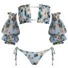 Nur Karaata Misty Mirage bikini featuring a vibrant, patterned bikini top and matching bottoms on a model.