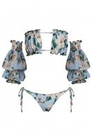 Nur Karaata Misty Mirage bikini featuring a vibrant, patterned bikini top and matching bottoms on a model.