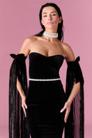 Nur Karaata Daisy Gown, elegant floral design with flowing fabric, showcased on a model for a stylish evening wear look.
