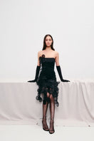 Black mini dress with floral appliqué details, sheer fabric, and long sleeves from MALVA FLOREA's floral appliqué mini dress collection.