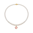 Pink and pearl heart necklace by Nana Jacqueline featuring a delicate chain and elegant heart pendant.