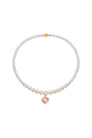 Pink and pearl heart necklace by Nana Jacqueline featuring a delicate chain and elegant heart pendant.