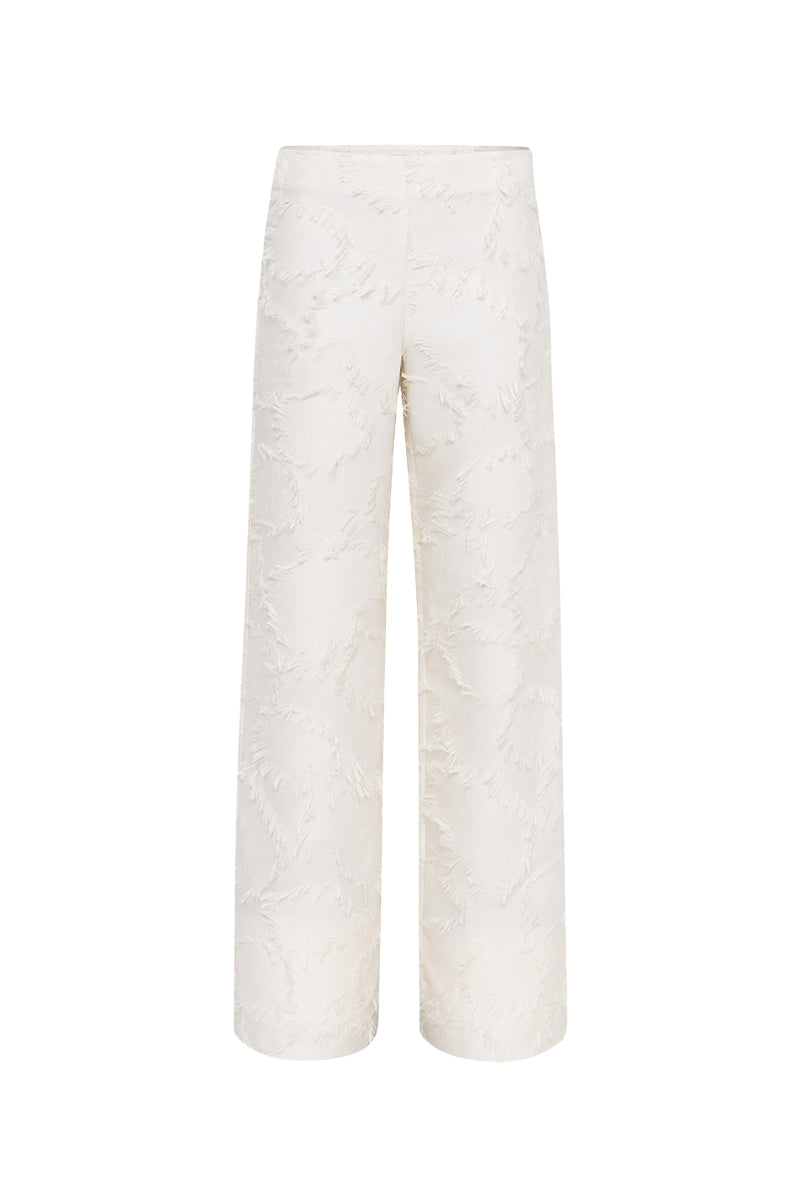 Cream Jora fringe trousers by Sélone, stylish pants with fringe detailing, showcased on a model against a neutral background.