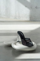 Black patent Fiorellini glass mules sandals by House of Atana featuring sleek design and transparent glass heel detailing.