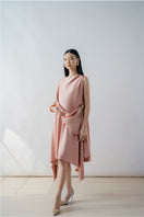 Rose pink draped asymmetric sleeveless midi dress by DOC BAN, showcasing elegant fabric and stylish asymmetrical design.