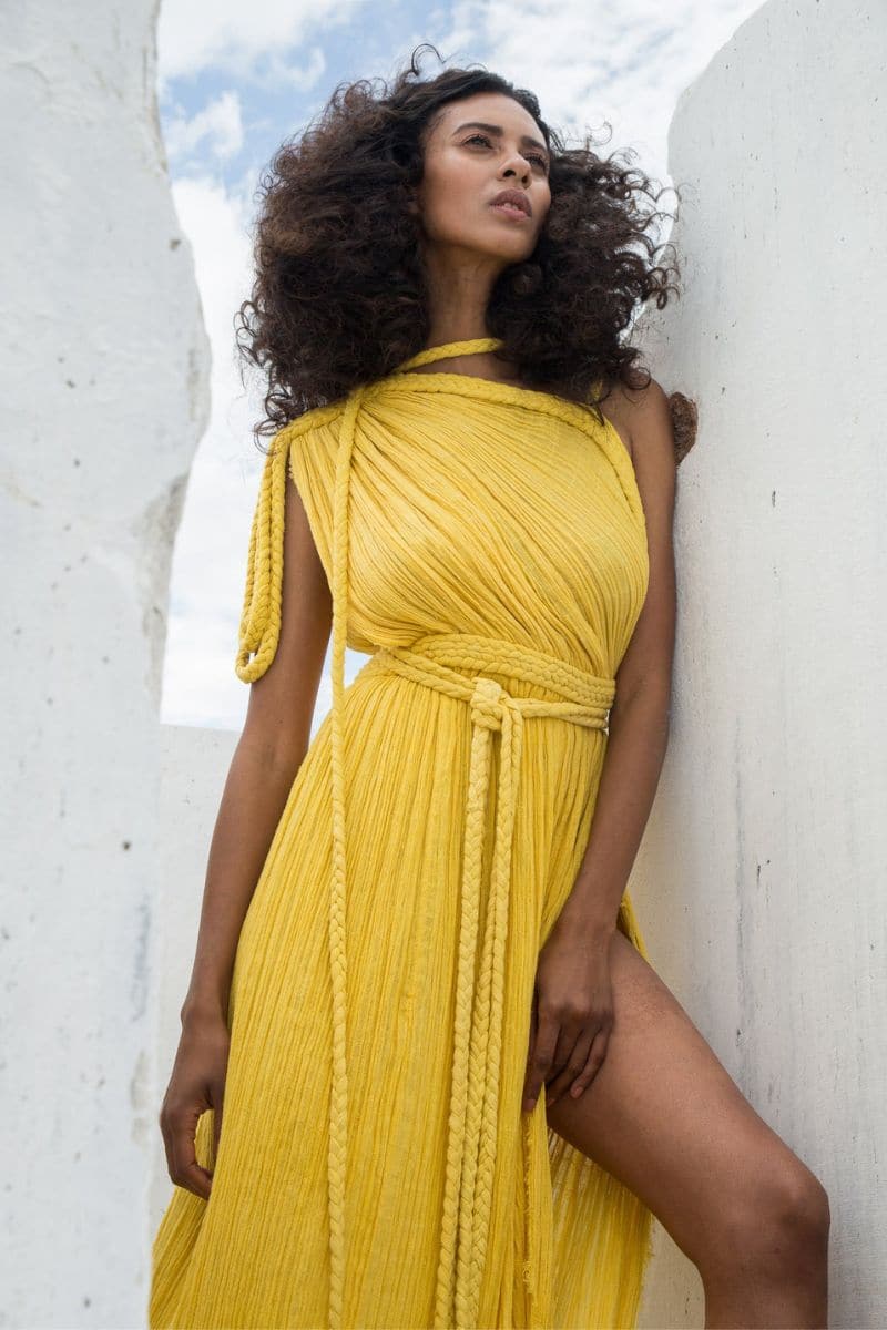 Kasia Kulenty Luna gown in Sol, a flowy maxi dress with soft fabric and elegant design, shown in a vibrant sunlight-inspired color
