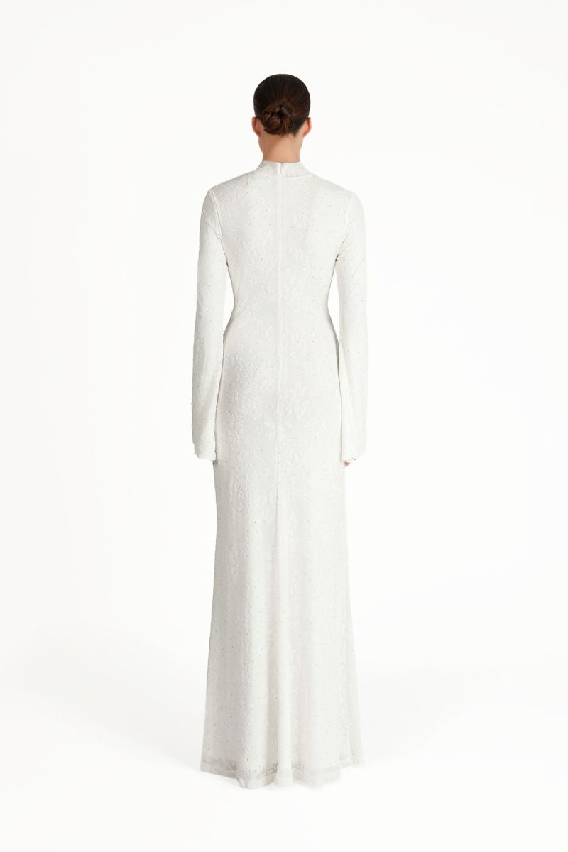 Khanum's white Keli maxi dress displayed on a hanger, featuring a flowing fabric and elegant design for casual or formal occasions.