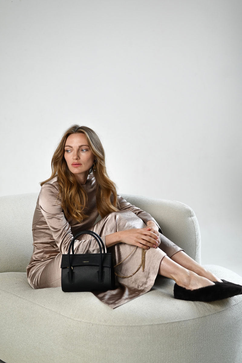 Black CELINE mini top handle bag from VIKELE STUDIO featuring sleek design and top handle straps.