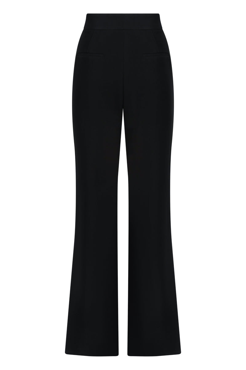 Black wide-leg trousers by Lili Blanc with a high waist and relaxed fit, showcased on a model.