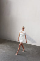 Nazlı Ceren Martine sequin mini dress in cloud cream, featuring shimmering sequins and a fitted silhouette on a model.