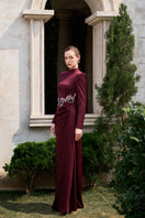 Elegant burgundy crystal silk long sleeve gown by Tracy Studio with flowing fabric and intricate details.