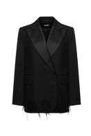 Vaska black distressed jacket with ripped details, stylishly worn, showing front view with collar and button closure.
