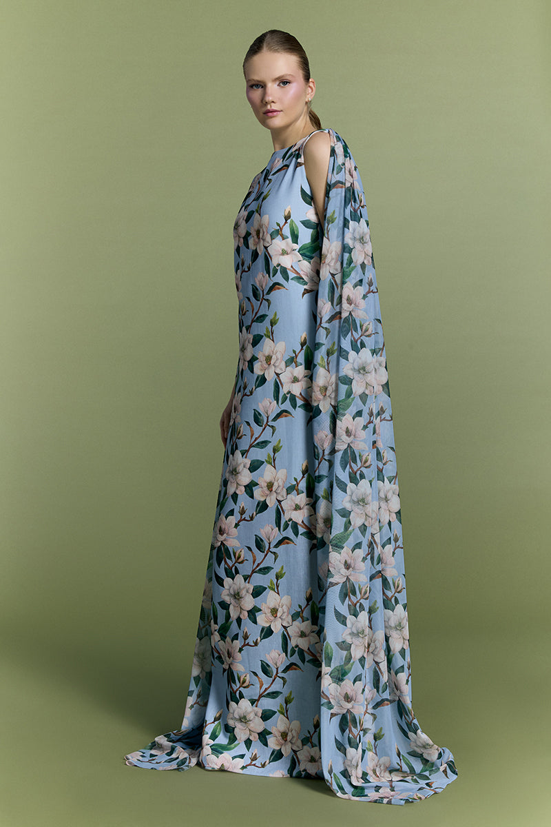 Nur Karaata Whisper Wind gown featuring flowing fabric and elegant design, displayed on a mannequin with soft draping.
