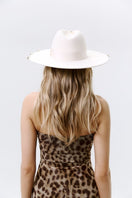 Ecru gold London hat by LE SH KA with 24K gold-plated accessories, featuring a stylish wide brim and elegant design.