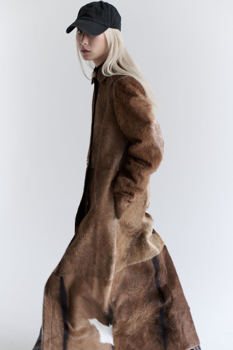 ZUT Flemington leather coat displayed on a hanger, featuring classic design and smooth dark leather finish.